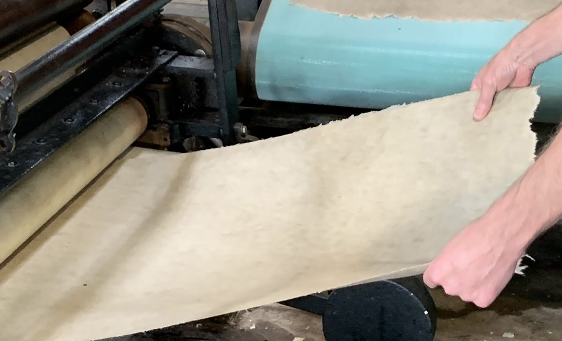 removing the pressed paper, making it ready to dry