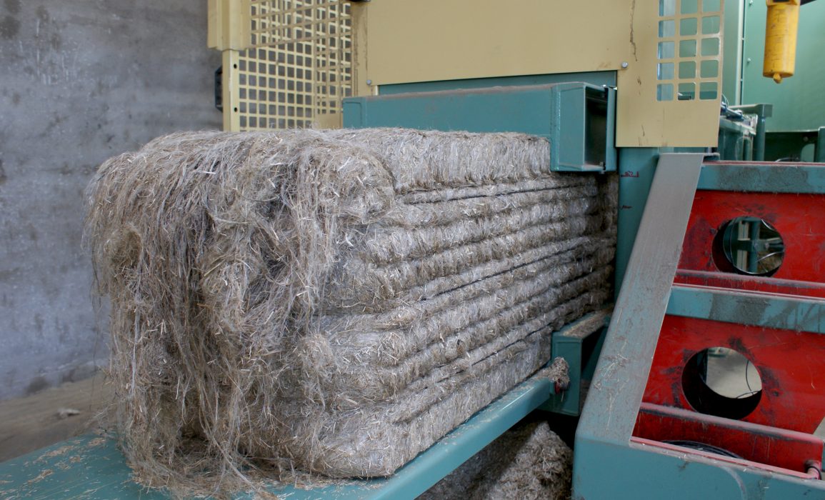 a compressed 40 kg bale of the shorter hackling tow